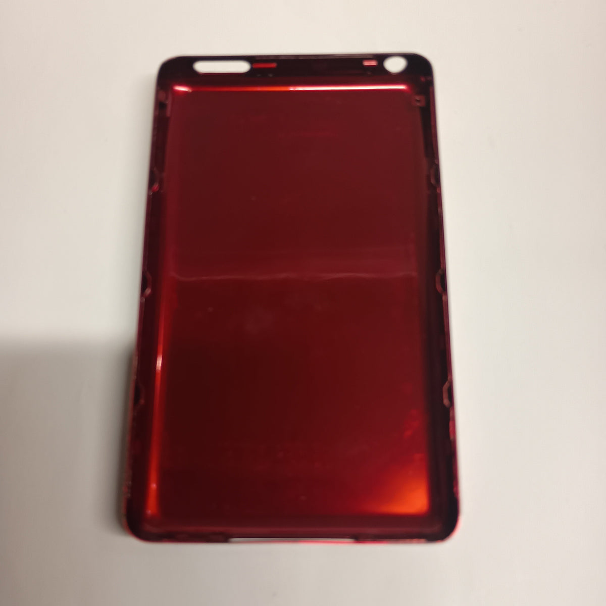 Interior view of a red iPod Classic replacement rear housing with a reflective metallic finish