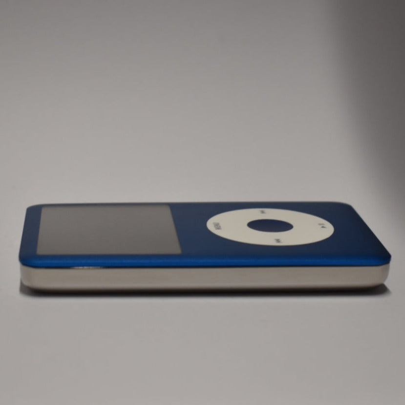 Side view of a blue iPod Classic with a white click wheel and polished silver rear housing