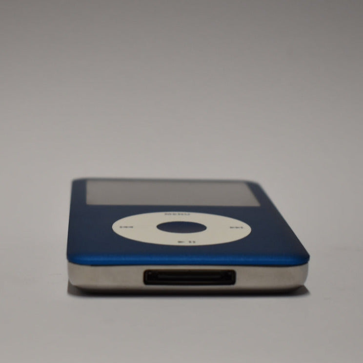 Blue iPod Classic with a white click wheel and matching blue centre button, viewed from the bottom edge