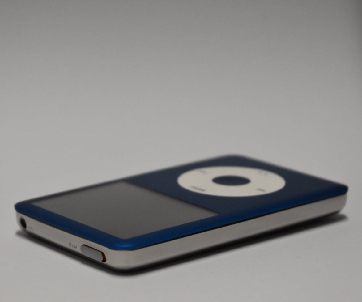 Angled view of a blue iPod Classic with a white click wheel and polished silver rear housing