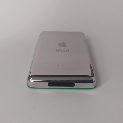 Rear view of a green iPod Classic showing its polished silver back with iPod and 1TB engraving
