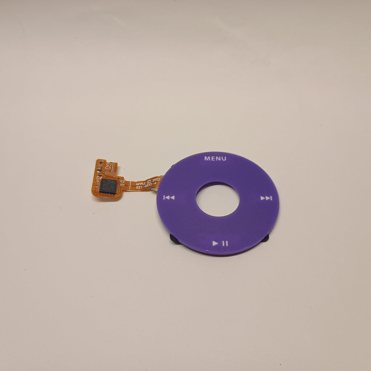 Purple iPod Classic replacement click wheel with white control markings and an attached orange ribbon cable