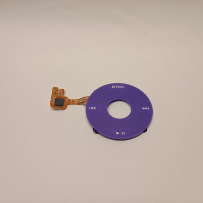 Purple iPod Classic replacement click wheel with white control markings and an attached orange ribbon cable
