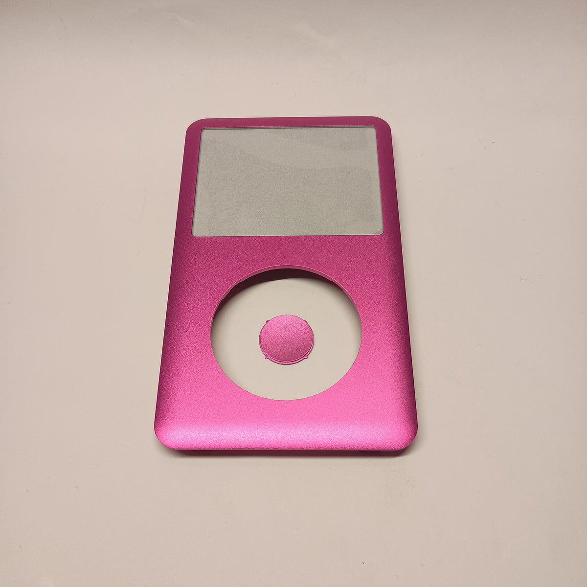 Front view of a pink iPod Classic replacement front housing with a matching centre button and screen window