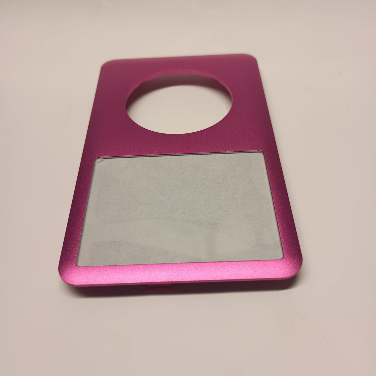 Pink iPod Classic replacement front housing, viewed from the screen end at a low angle