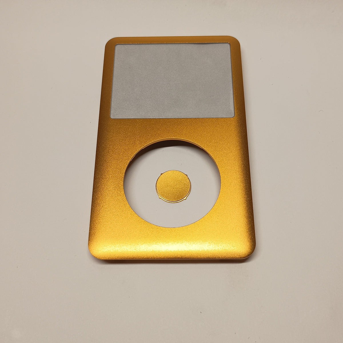 Front view of a gold iPod Classic replacement front housing with a matching centre button