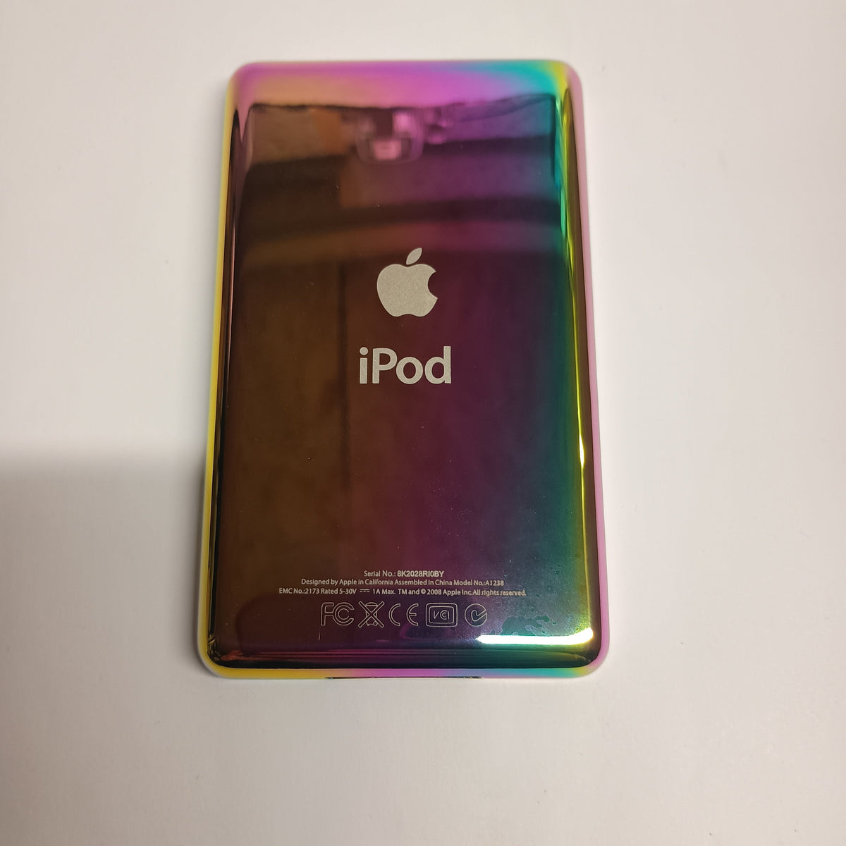 Polished rainbow-finish iPod Classic replacement rear housing, shown from the back with Apple and iPod engraving