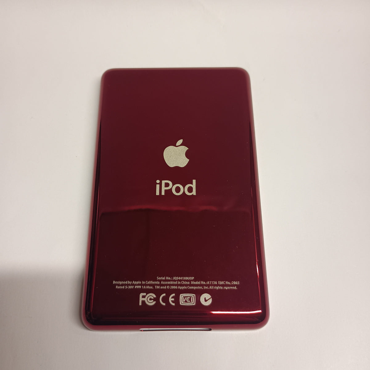 Polished red iPod Classic replacement rear housing, shown from the back with Apple and iPod engraving