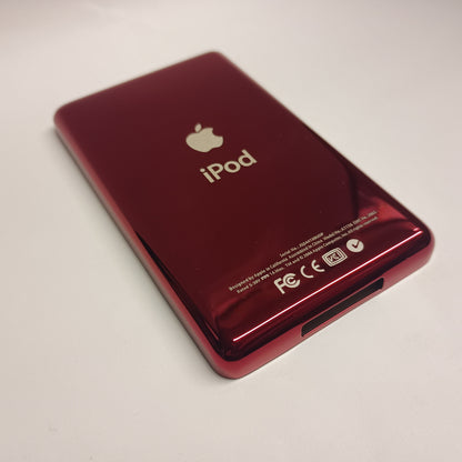 Angled view of a polished red iPod Classic replacement rear housing with Apple and iPod engraving